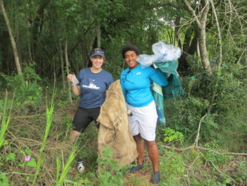 Volunteers comb the banks of the Ashley River for trash.Lowell George