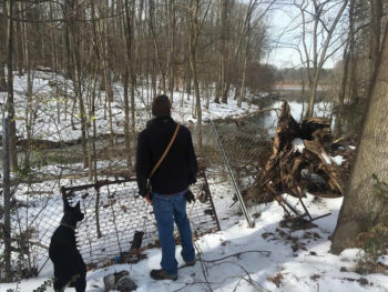 Will Scott and his dog Dash look out over Buck Pond. | Will Scott