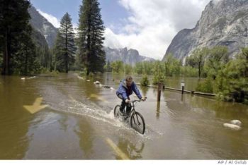 Chris Stewart bicycles down a flooded Chapel Straight in Yosemite National Park, Calif., Monday, May 16, 2005. | AP Photo/Al Golub
