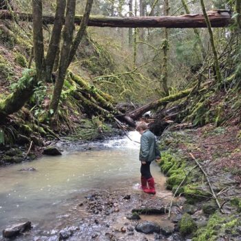 Child playing on the river. | Photo: Amy Kober