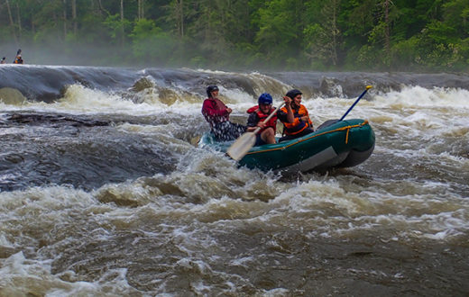 Melissa Martinez, Mike Huffman and local-legend Bruce Hare power through Dick’s Creek Ledge on a high-water Section 3 of the Chattooga. | Credit: Jack Henderson
