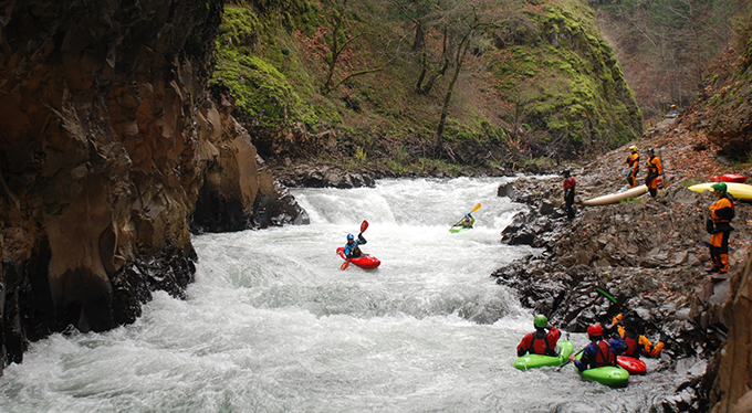 Susan Hollingsworth fires up Steelhead Falls at approximately 2' on the Husum gage, her first run down the newly restored Lower Gorge of the White Salmon River following the removal of Condit Dam. For nearly a century the river was diverted by the dam and placed in a pipe to bypass this section of river that now flows freely. Photo by Thomas O'Keefe.