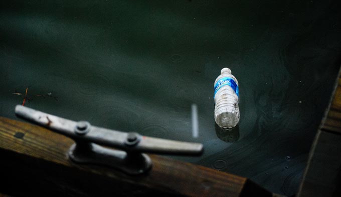 A water bottle floats in a river. | Chesapeake Bay Program