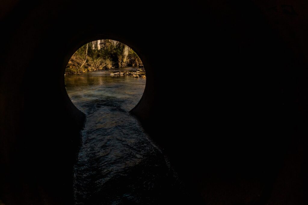 Culvert moving water | Photo by Timothy Brock via Unsplash