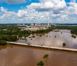 Jackson, MS Skyline with flooding Pearl River in the foreground in August 2022