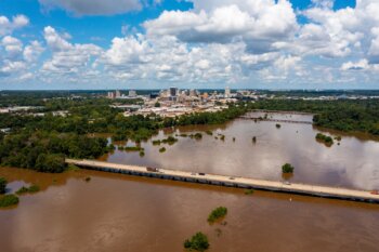 Jackson,,Ms,Skyline,With,Flooding,Pearl,River,In,The,Foreground Jackson, MS Skyline with flooding Pearl River in the foreground in August 2022