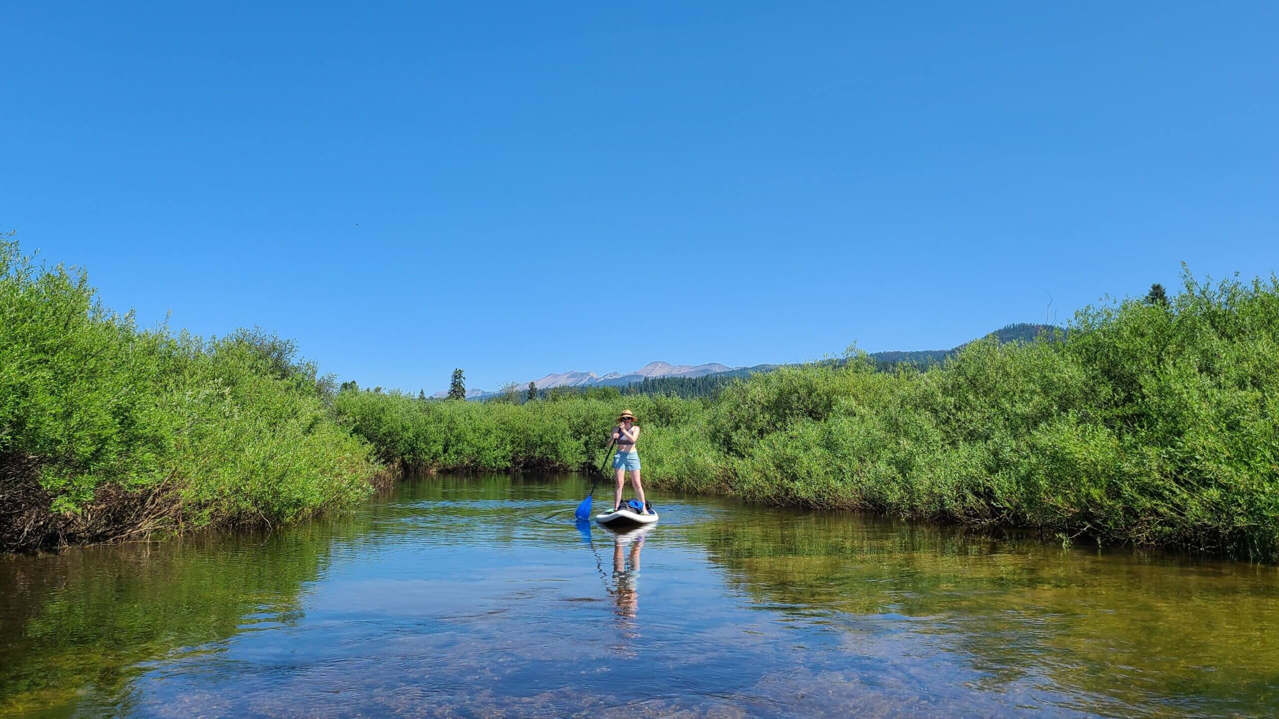 Stand up paddle boarder on Clearwater River | Photo by Jessy Stevenson