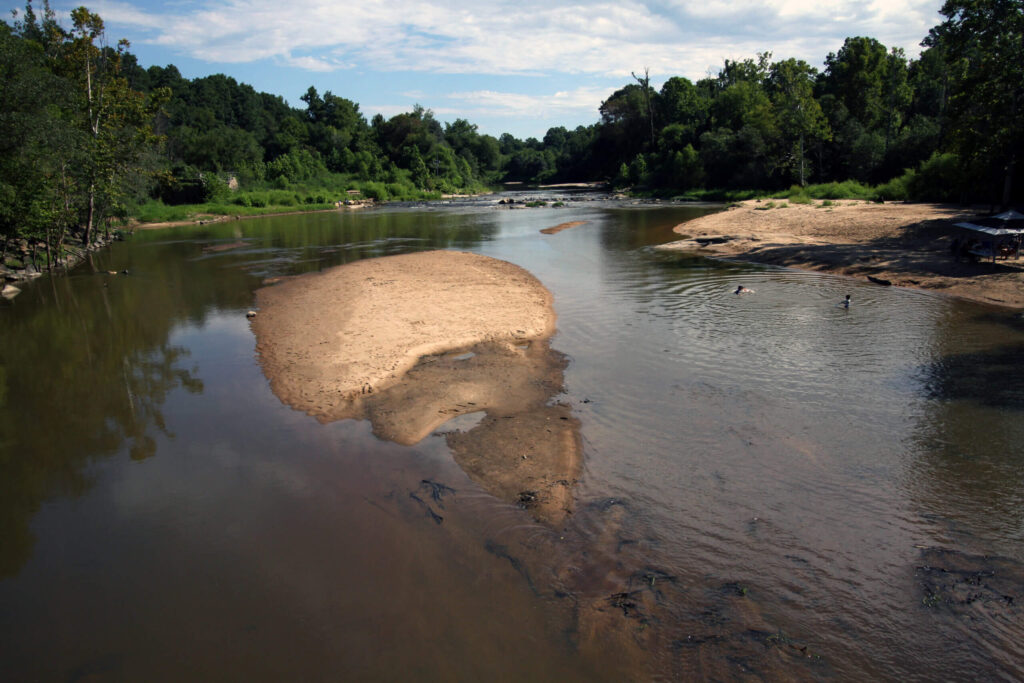 Children play in the clear water of the Neuse along the Neuse Greenway in Raleigh | Photo by Veil Stewart Rumley