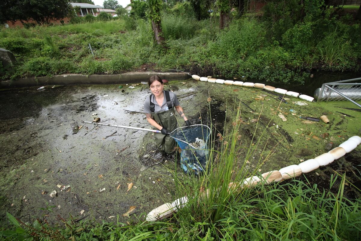 Neuse Riverkeeper Samantha Krop clears trash from a Sound Rivers’ Trash Trout on Duffyfield Canal in New Bern | Photo by Vail Stewart Rumley