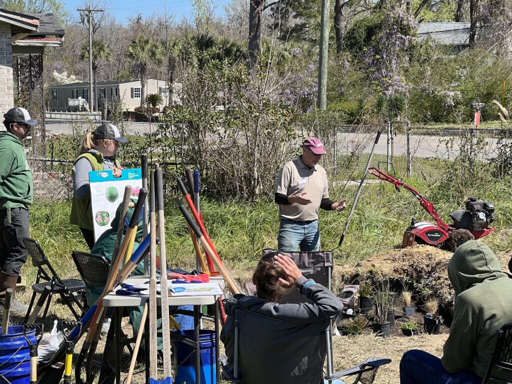 Installers provide instruction and explanation on the process for developing a rain garden.